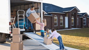 Family loading boxes into a moving truck while preparing for a move to Texarkana