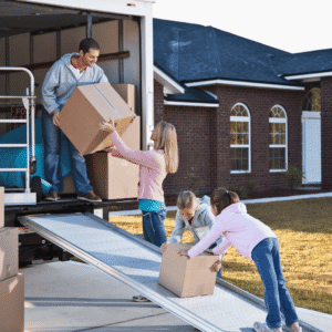 Family loading boxes into a moving truck while preparing for a move to Texarkana