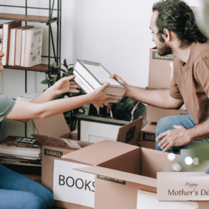 A couple organizing boxes and decluttering their home for Mother’s Day storage solutions